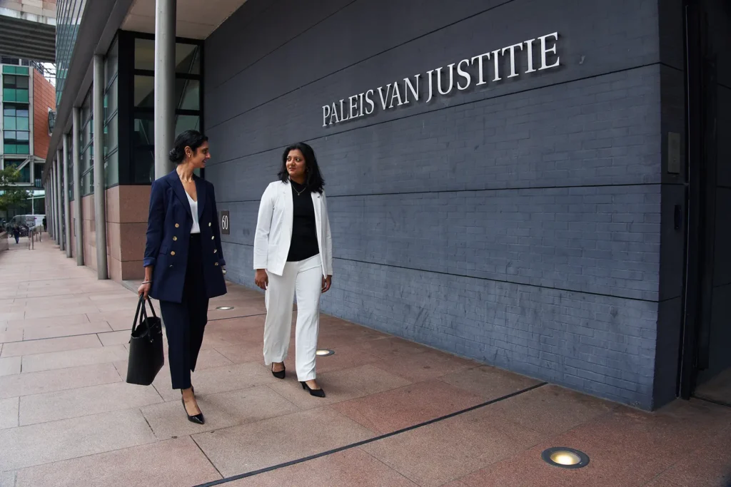 Two_women_walking_outside_courthouse