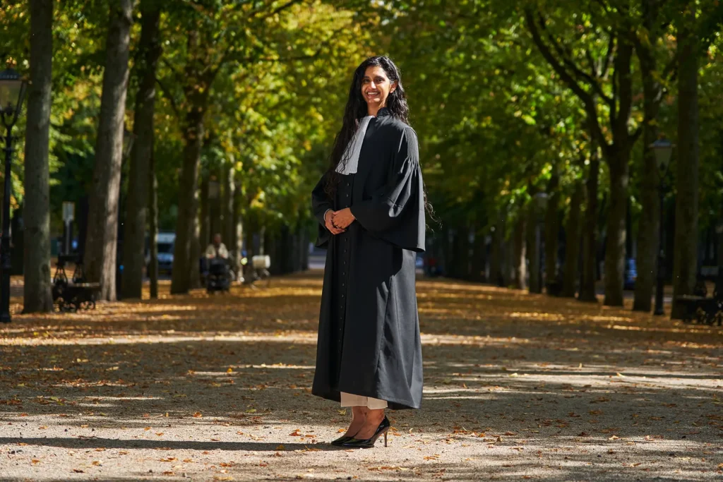 Woman_in_graduation_gown_outdoors